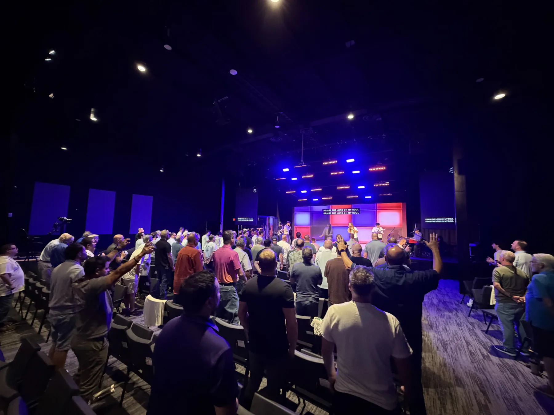 Men worship together beneath the Forge One Day stage lights