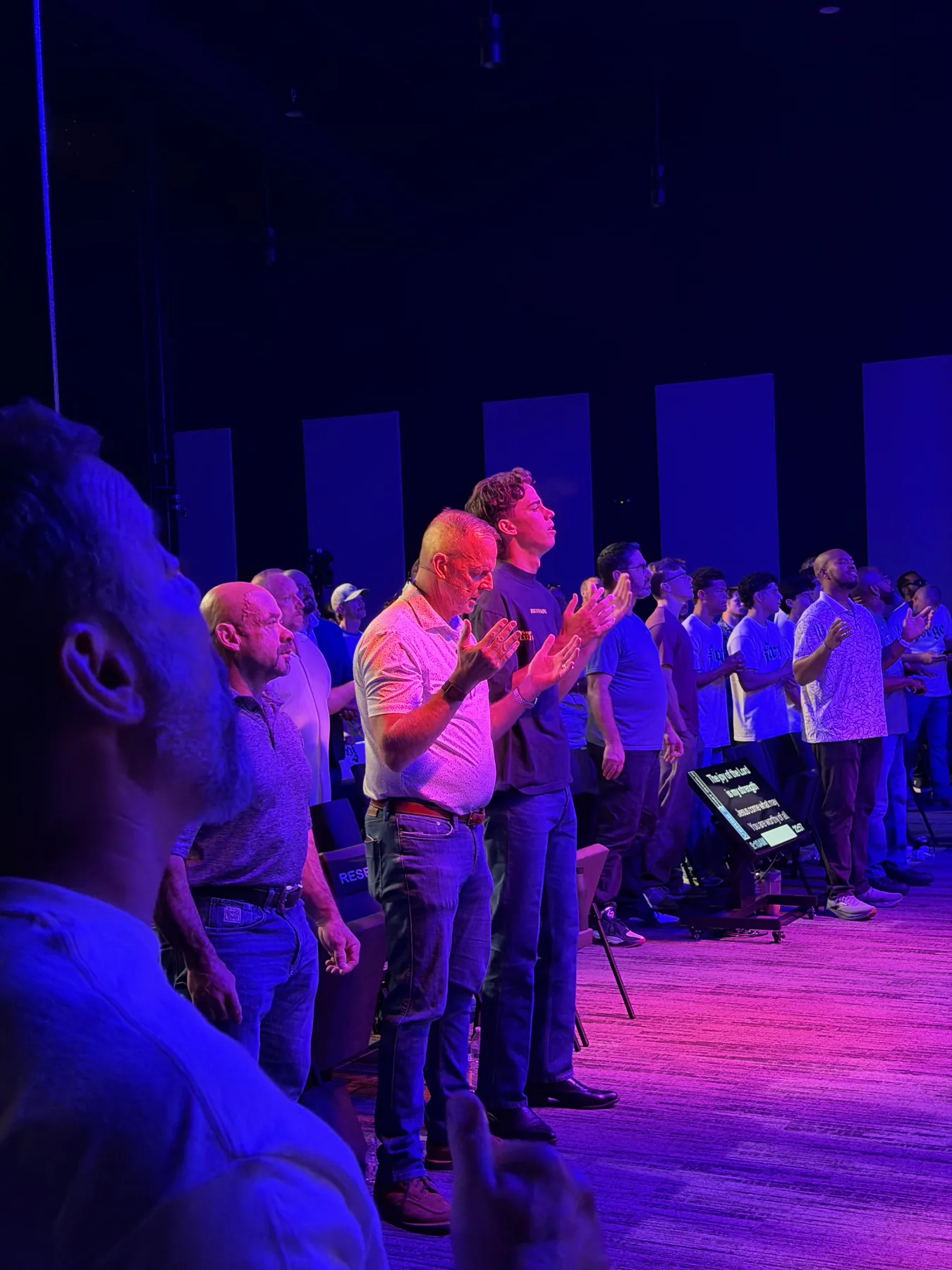Men face the stage during the Forge One Day worship set