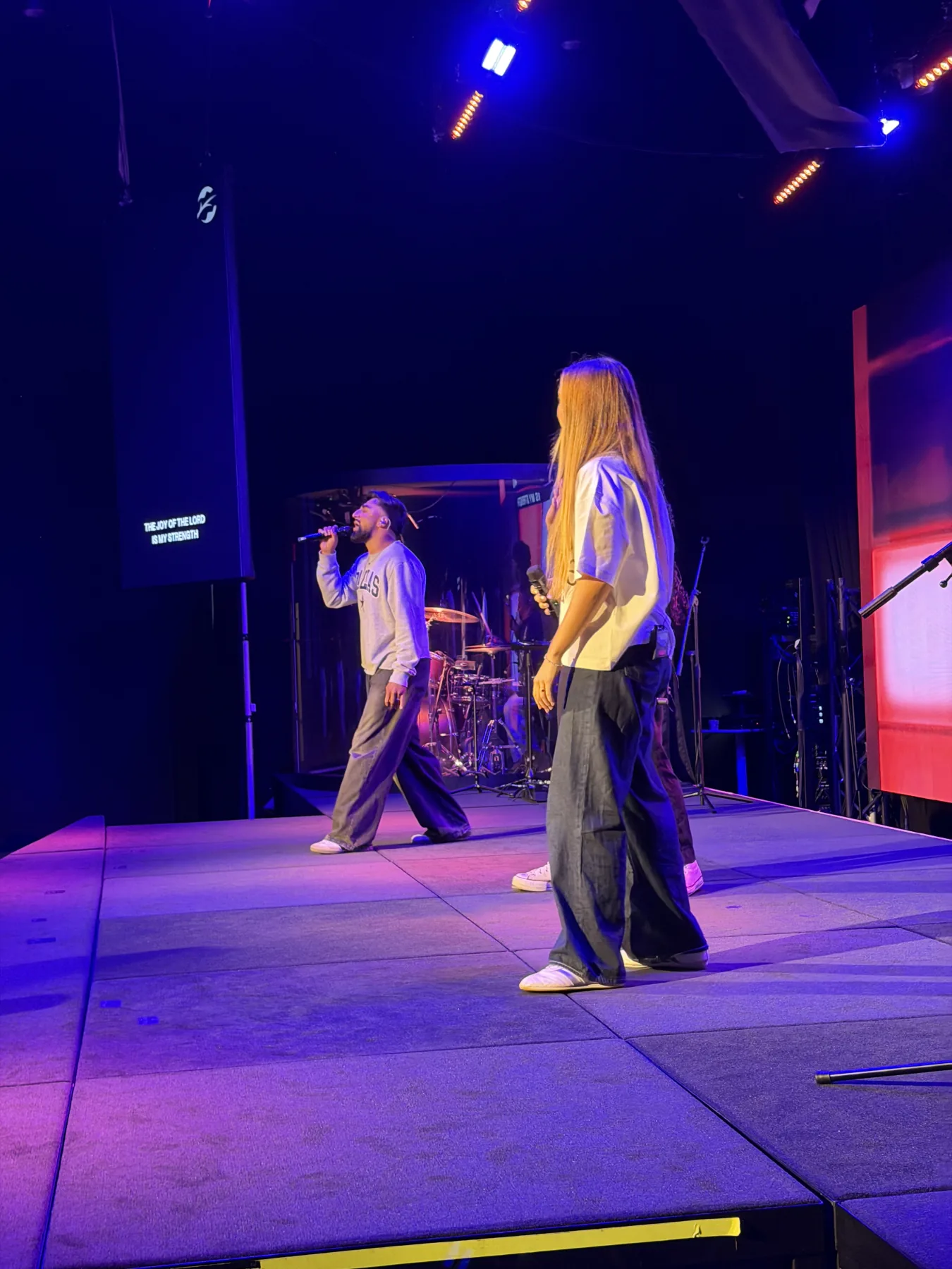 A vocalist leads worship from the Forge One Day stage