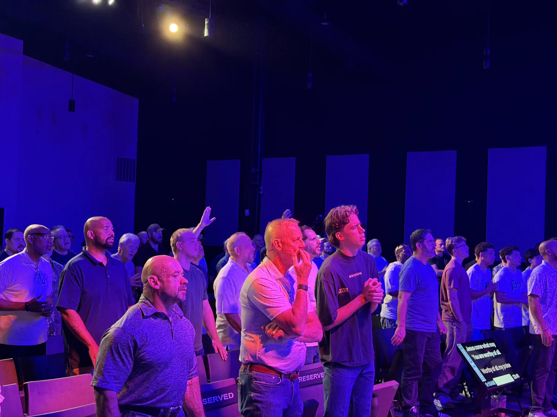 A side view of men worshiping together at Forge One Day