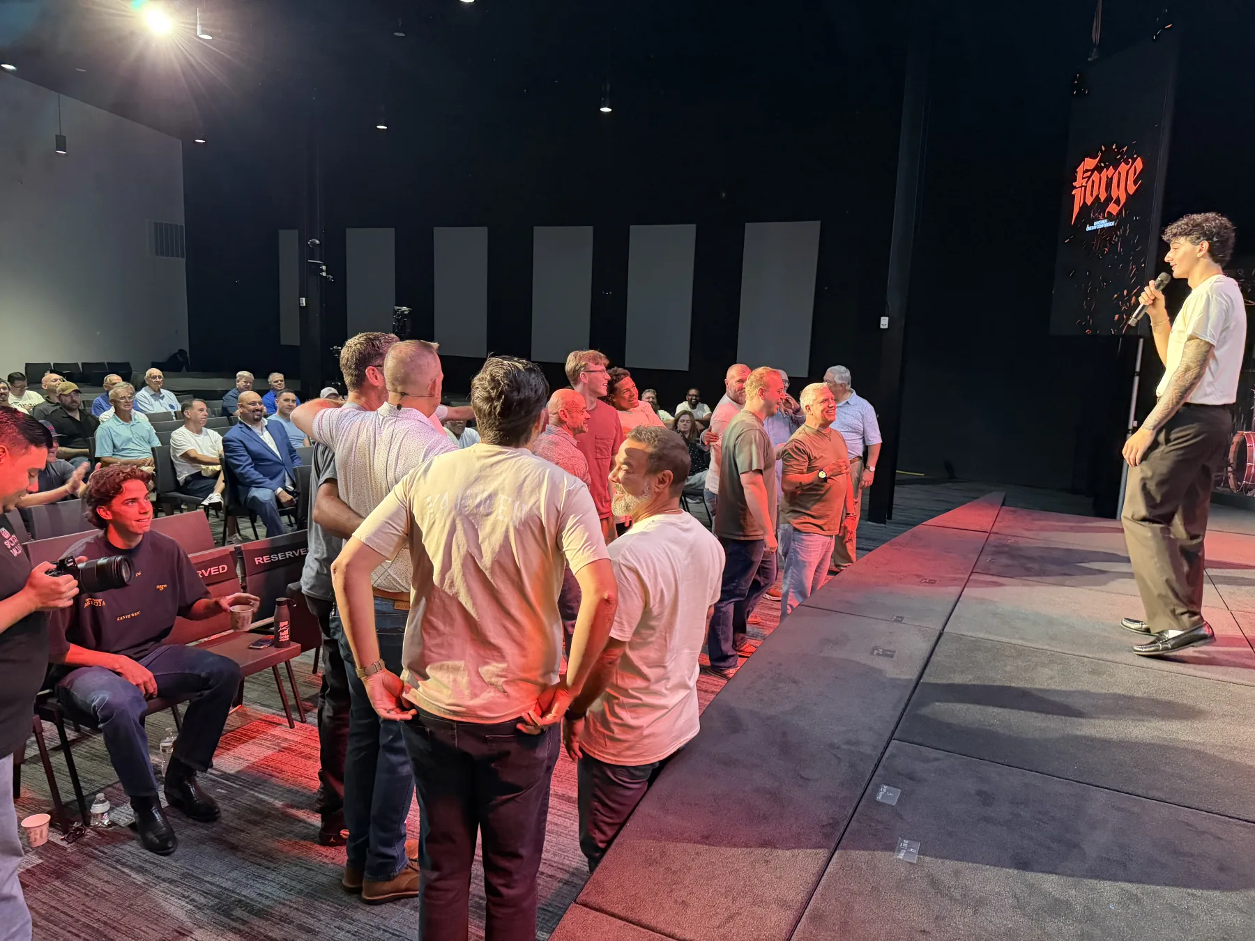Men step forward near the stage for an interactive Forge One Day challenge