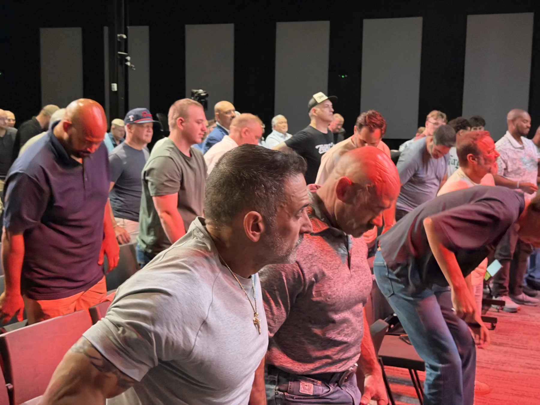 Men lean forward together during an interactive Forge One Day moment