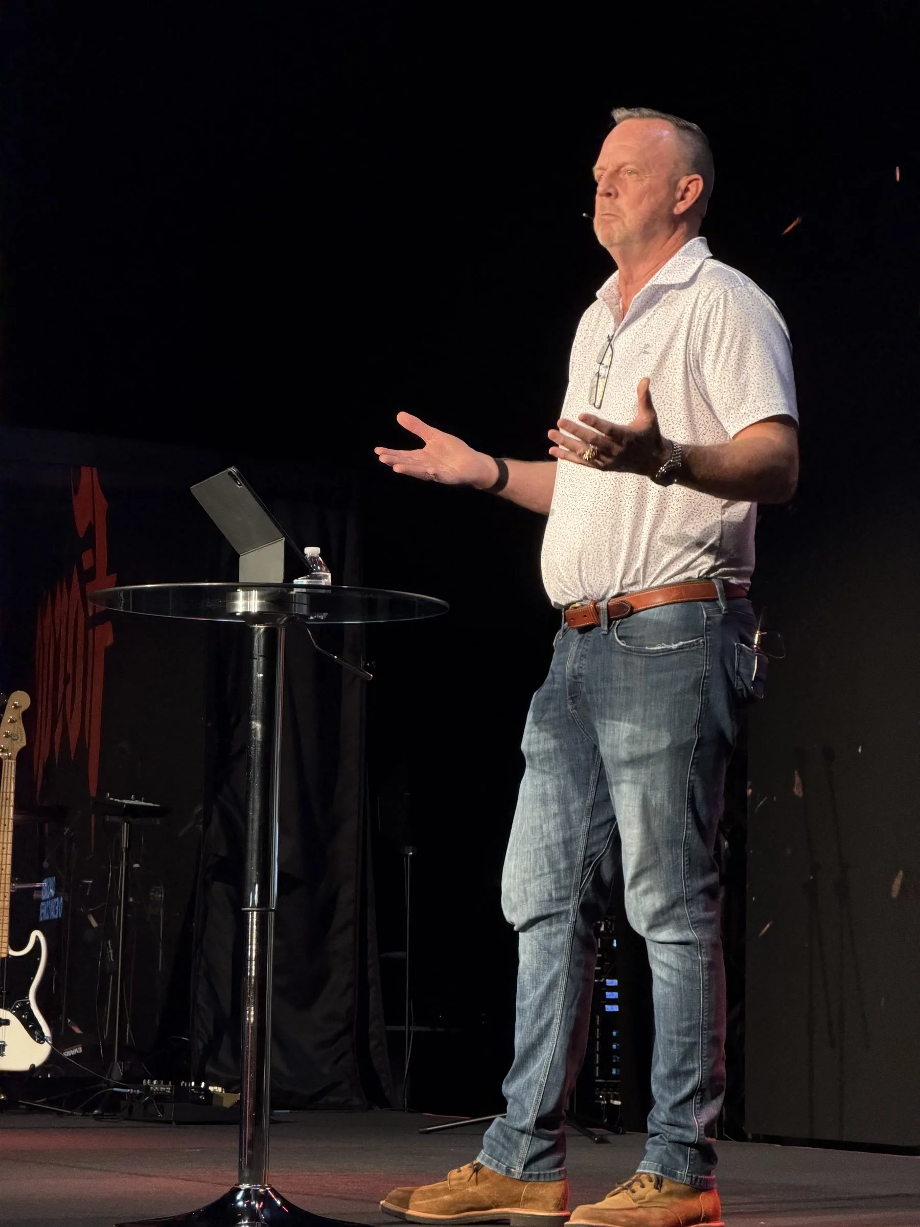 A speaker gestures while addressing the Forge One Day gathering