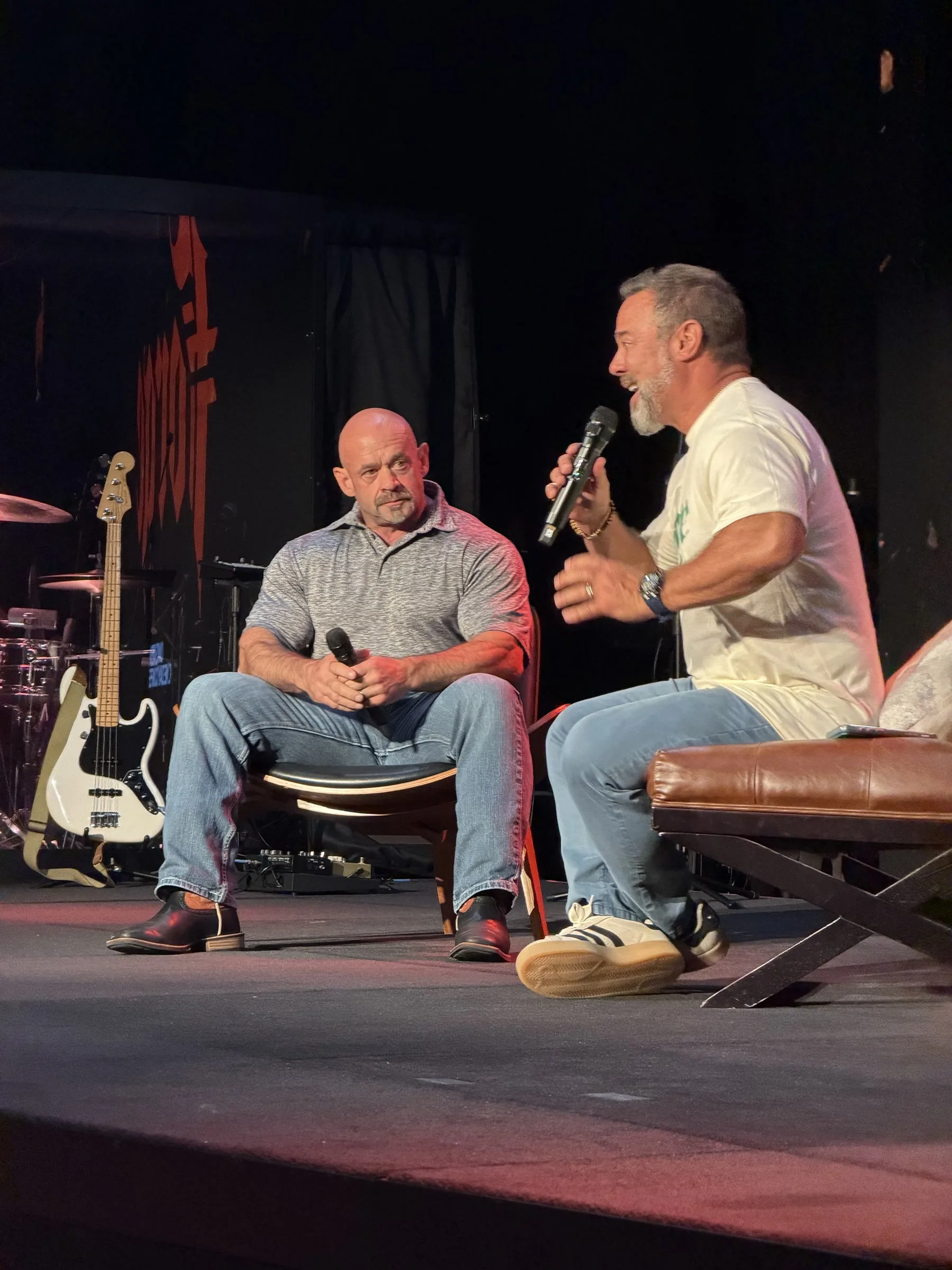 Two men sit in conversation during a Forge One Day session