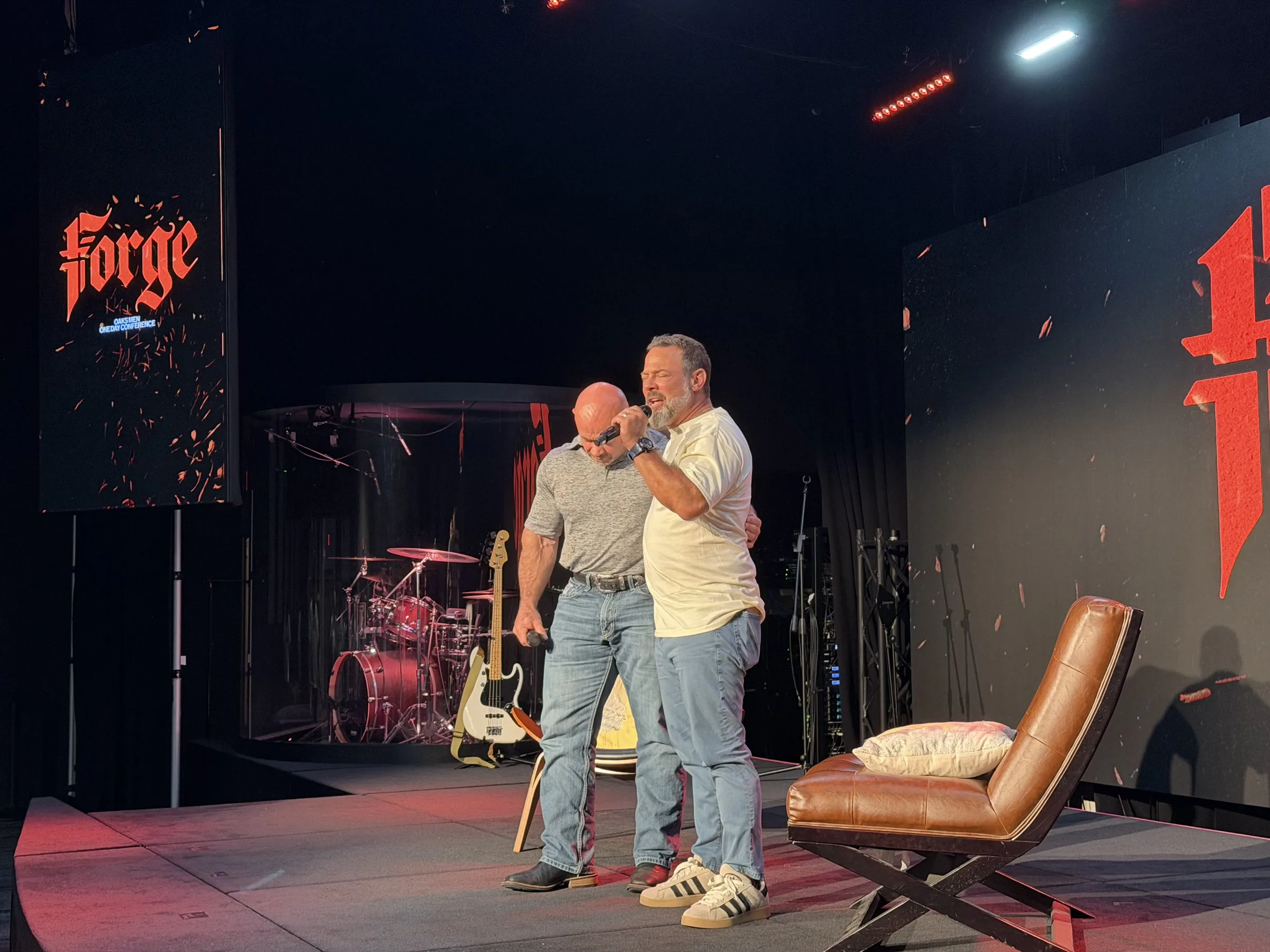Two men embrace on the Forge One Day stage