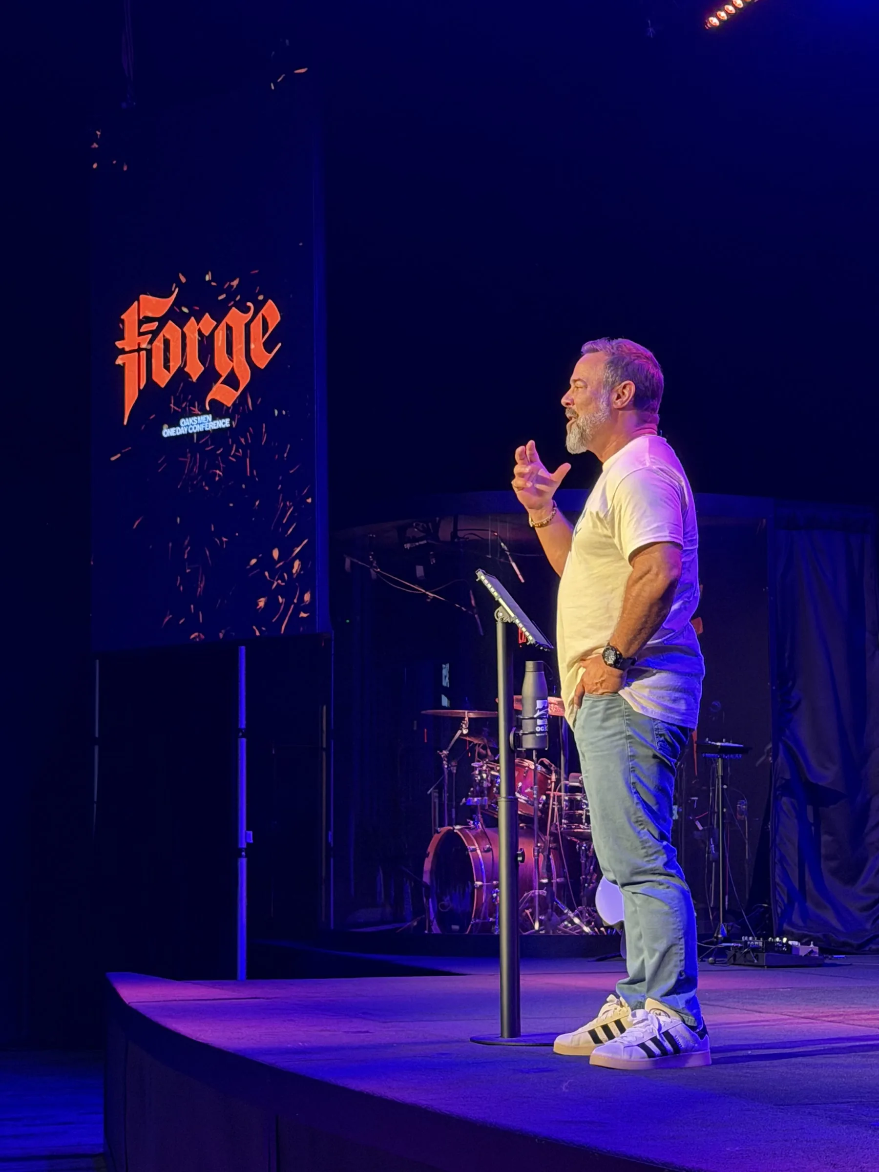 A speaker addresses the room from the Forge One Day stage