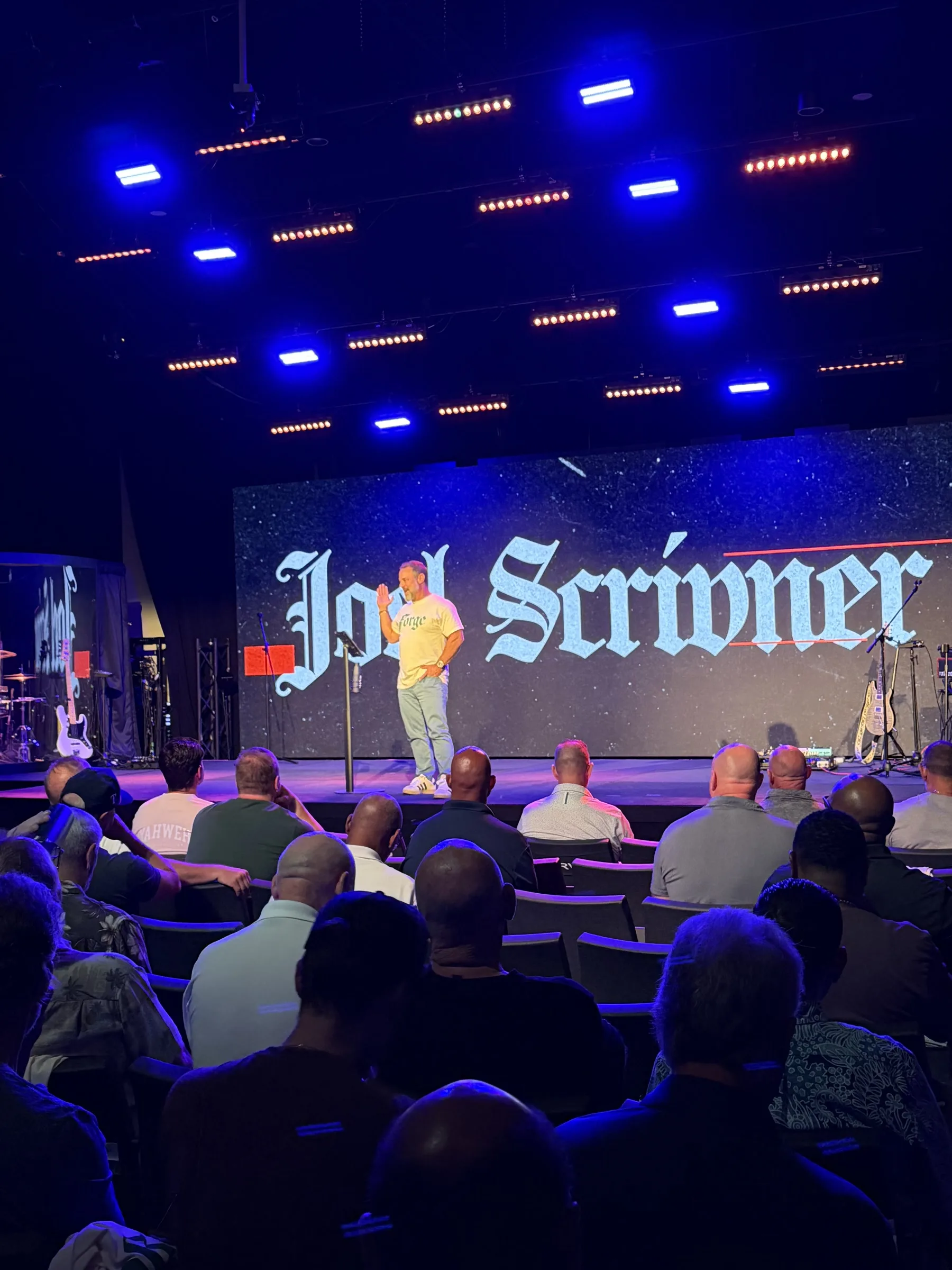 The auditorium watches Pastor Joel Scrivner speak during Forge One Day
