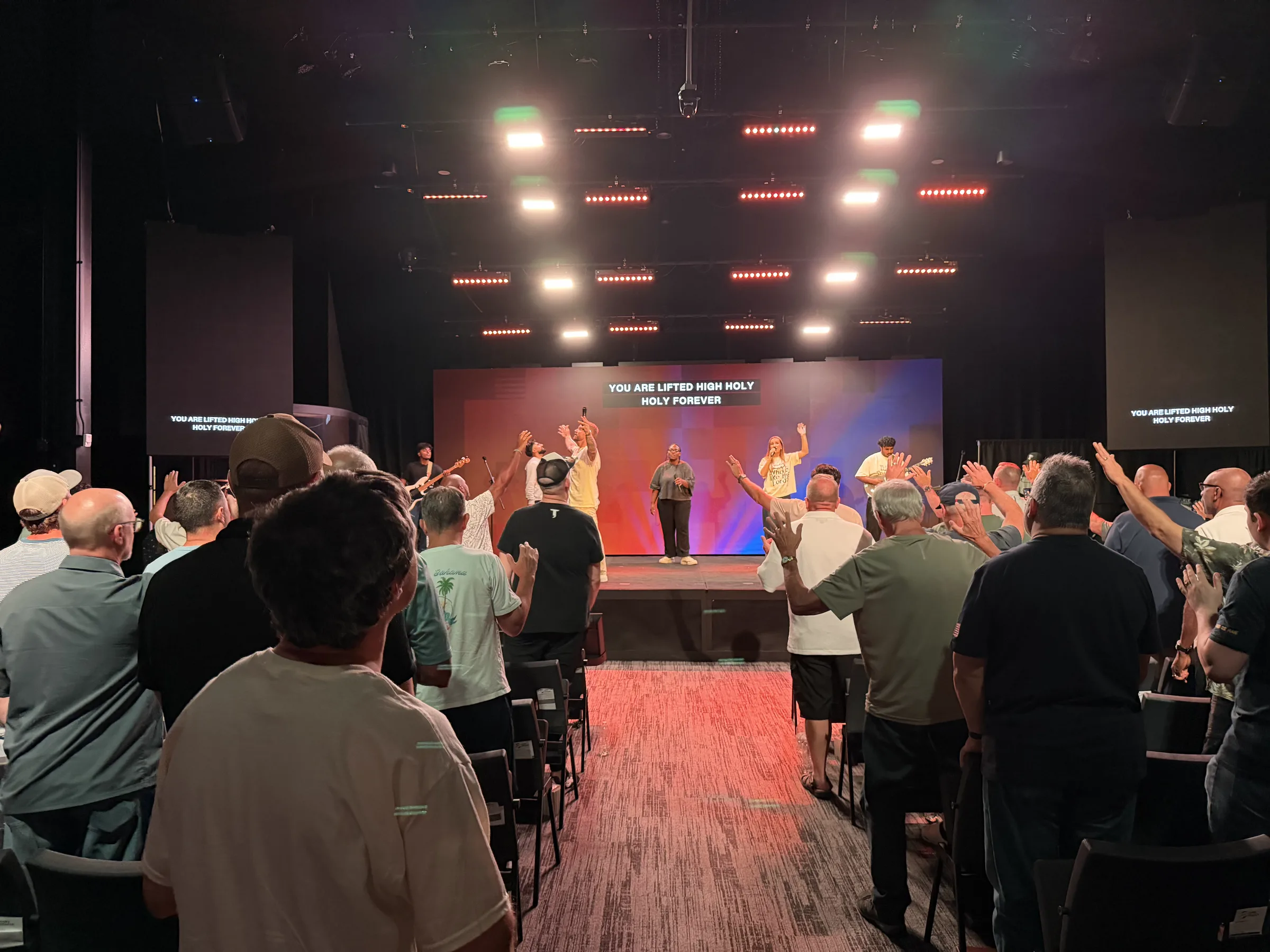 Men worship from the center aisle as the team leads Holy Forever on the Forge One Day stage